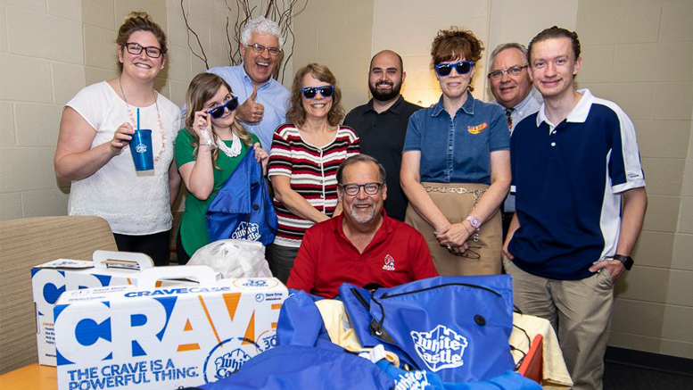 ohn Carlson (seated) is pictured along with Woof Boom Radio staffers in this MuncieJournal.com archived photo from 2018 after receiving free White Castles and swag from White Castle corporate. Photo by Mike Rhodes