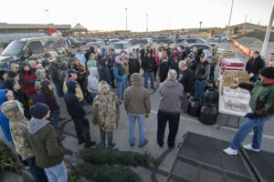 Volunteers gather for last minute instructions prior to delivering gifts as part of Secret Families. Photo by Mike Rhodes