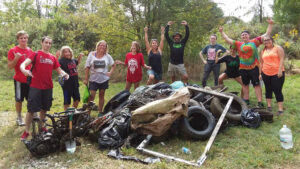 Canoe group volunteers pose with their haul of trash rescued from the White River at the 2017 clean-up event. Photo courtesy MuncieJournal.com